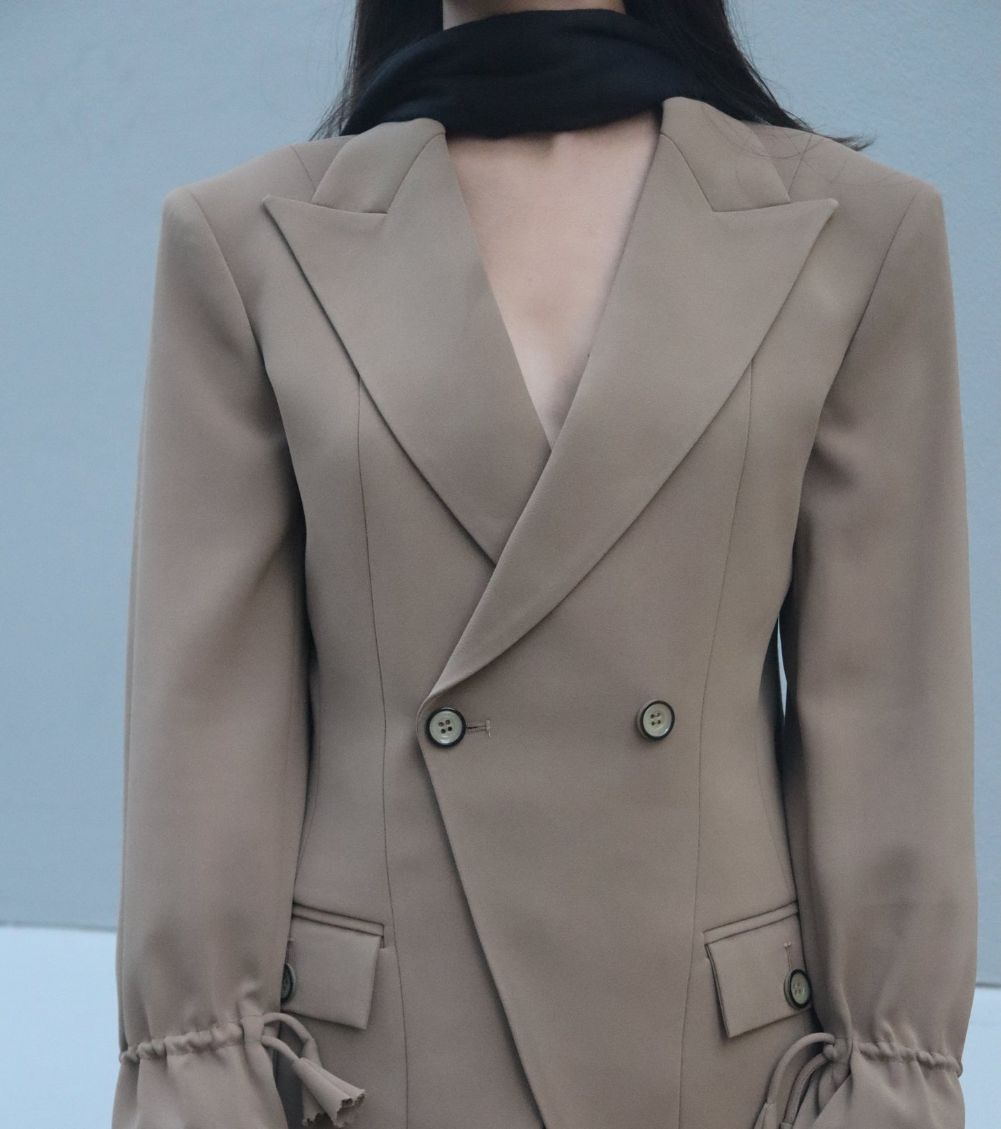 Beige Blazer set suit with buttons on a light gray background